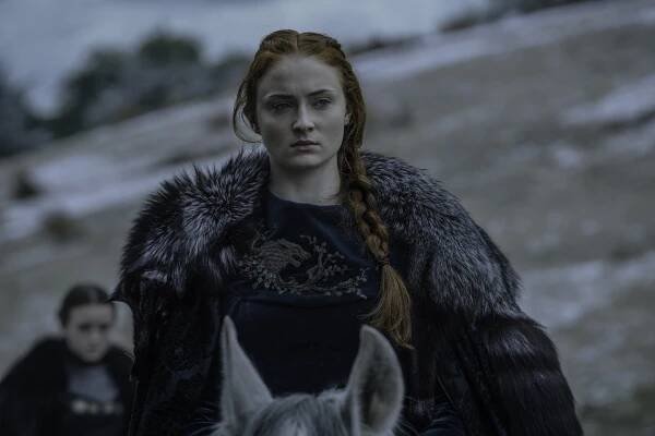 Sansa Stark in a fur cloak, on horseback.