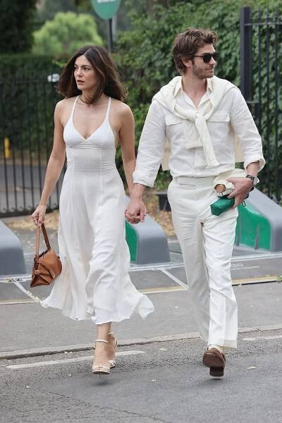 Monica Barbaro and Andrew Garfield arrive at All England Lawn Tennis and Croquet Club for Wimbledon wearing all-white matching outfits on July 06, 2025