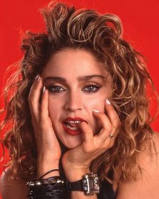 A portrait of Madonna on a red background.