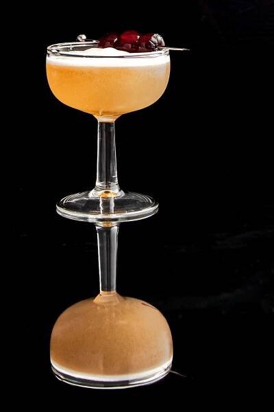 non alcoholic whiskey sour garnished with cherries.