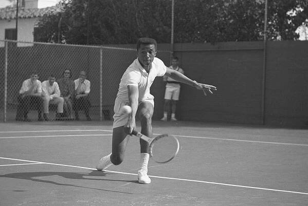 UCLA tennis player Arthur Ashe firing a backhand volley at Dennis Ralston in Southern California Intercollegiates 1964