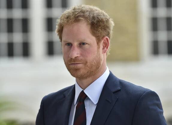 a man with a beard is wearing a suit and tie