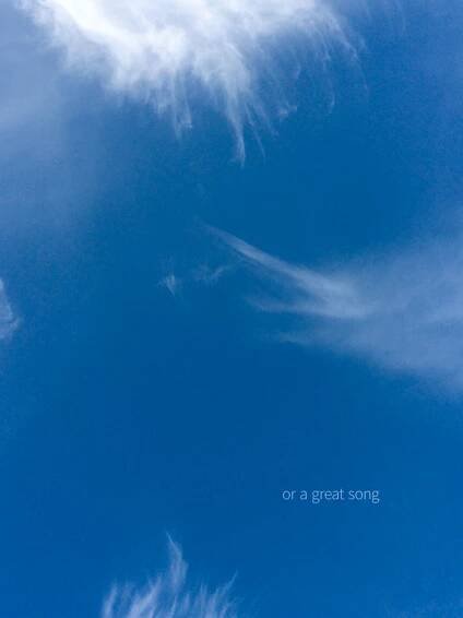 A photograph of whispy clouds in a blue sky with the words "or a great song"