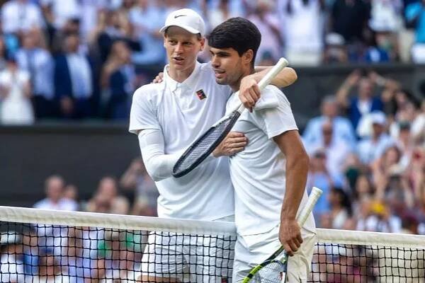 Winner Jannik Sinner of Italy and Carlos Alcaraz of Spain embrace at the net after the Gentlemen's Singles Final on Centre Court during the Wimbledon Lawn Tennis Championships at the All England Lawn Tennis and Croquet Club at Wimbledon on July 13th, 2025, in London, England. 