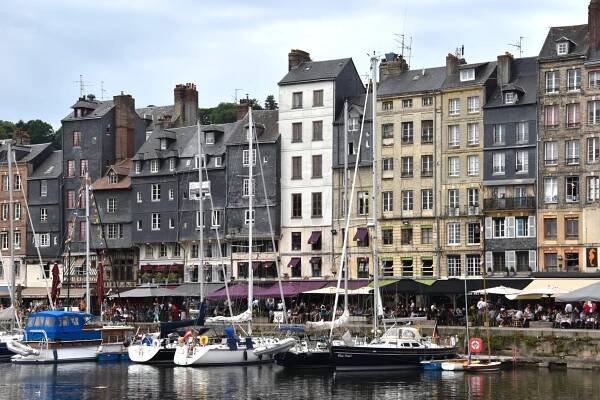 La Vieux Bassin, a close up of a row of houses, with boats in front in the harbor