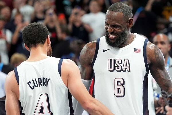 LeBron James of USA and Stephen Curry of USA celebrate during the Men's Basketball semi-final match between USA and Serbia on Day 13 of the Olympic Games Paris 2024 at Bercy Arena on August 8, 2024 in Paris, France.