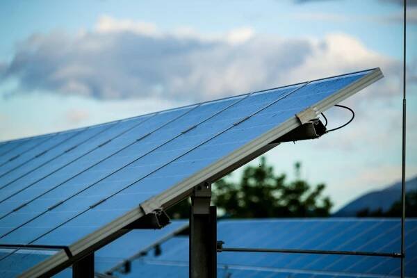 a close up of a solar panel with a cloudy sky in the background .