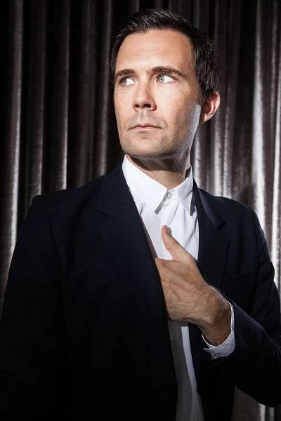Image may contain Oz Perkins Clothing Formal Wear Suit Accessories Tie Face Head Person Photography and Portrait
