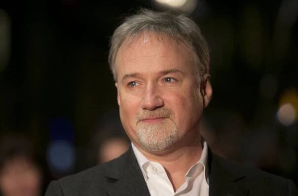 HOLD FOR STORY - FILE - In this Jan. 13, 2013 file photo, director David Fincher arrives on the red carpet for the Netflix UK Premiere of 'House of Cards' at a Leicester Square cinema in London. Ben Affleck and Fincher are reteaming for a remake of Alfred Hitchcocks Strangers on a Train.  On the heels of their 2014 box-office hit 
