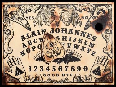 A Ouija board set up and ready for use Wallpaper