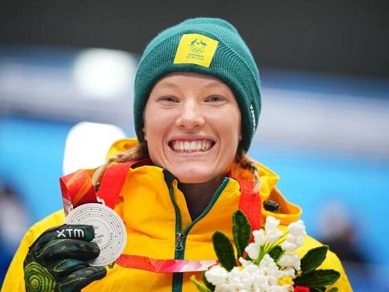 Jaclyn Narracott smiles holding a medal