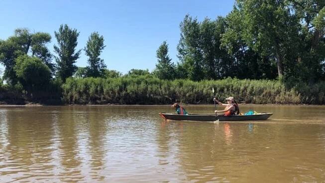 kayaking with dog on brown waterway