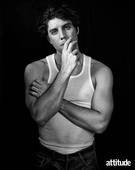 Lukas Gage in a white vest against a black backdrop