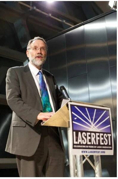 Figure 19. Allister Ferguson at the Laserfest event at the Glasgow Science Centre where ‘50 Years of the Laser in Scotland’ was launched. Speakers at the event included Nobel laureates Steve Chu, Roy Glauber and Eric Cornell. Local speakers included Dave Hanna, Ed Hinds and Steve Barnett. 