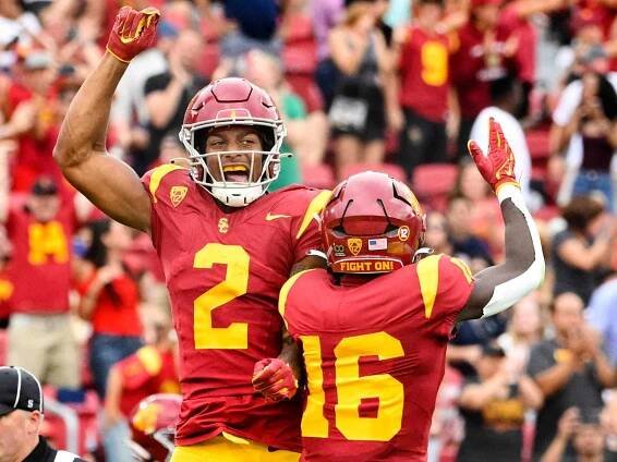 Brenden Rice #2 of the USC Trojans celebrates with teammate wide receiver Tahj Washington #16 of the USC Trojans in the first half of a NCAA football game at the Los Angeles Memorial Coliseum in Los Angeles on Saturday, September 2, 2023.