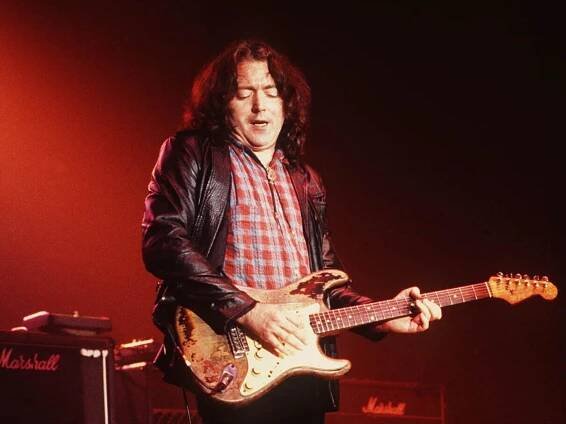 Rory Gallagher performing with his Fender Stratocaster