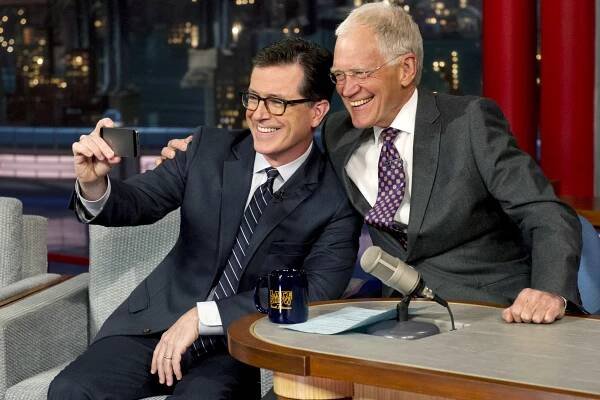 Stephen Colbert, left, takes a "Selfie" with host David Letterman on "Late Show with David Letterman" Tuesday night.