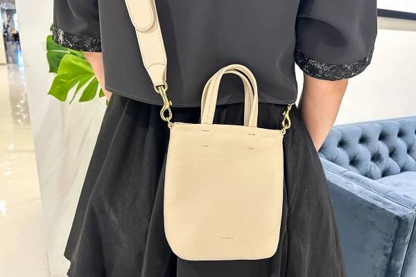 A person wearing the Cuyana Easy Phone Tote Bag