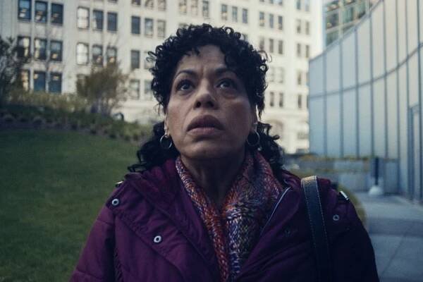 Liza Colón-Zayas stands outside a building