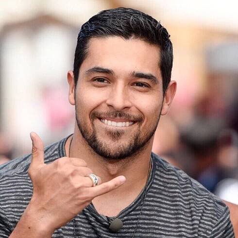 a man with a ring on his finger giving the peace sign