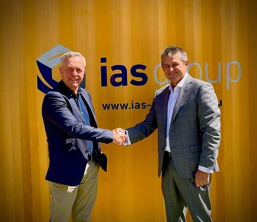 Jim Beveridge and Russell Collins shake hands