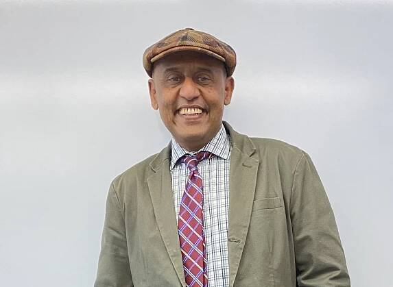 Medium shot of Muhammad Khan in front of a white background