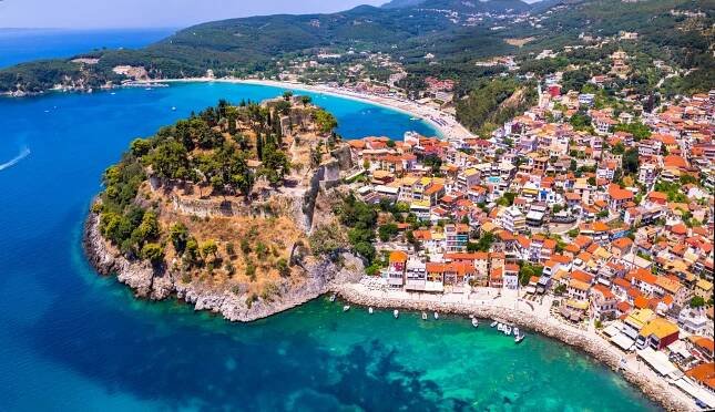 A picturesque Greek region — colorful houses above turquoise water. The most beautiful islands of Greece.