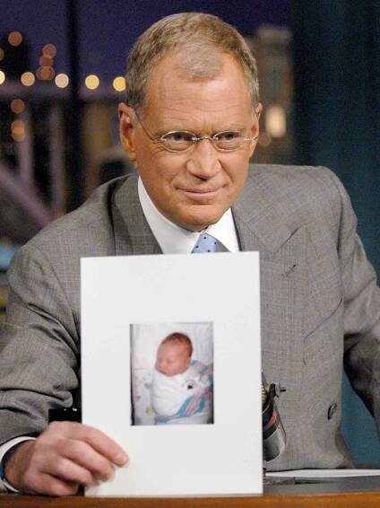 David Letterman holds a photo of his new son, Harry Joseph Letterman during 'The Late Show with David Letterman' on November 4, 2003.