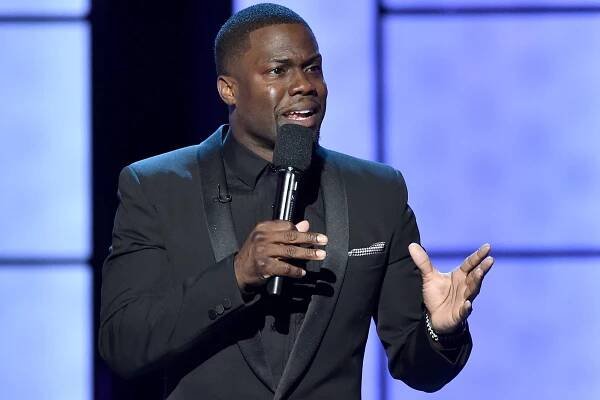 Kevin Hart speaks onstage at a roast.