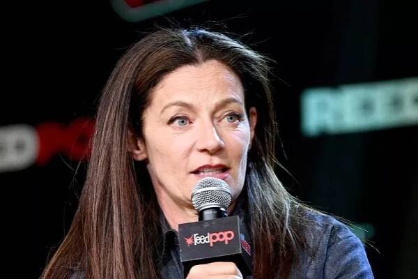 A woman speaks on a microphone