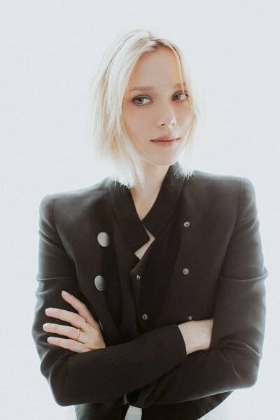 actress ivanna sakhno poses crossing her arms and waering a black blazer