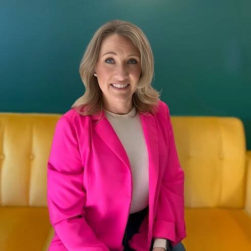 Joy Smiling on Yellow Couch