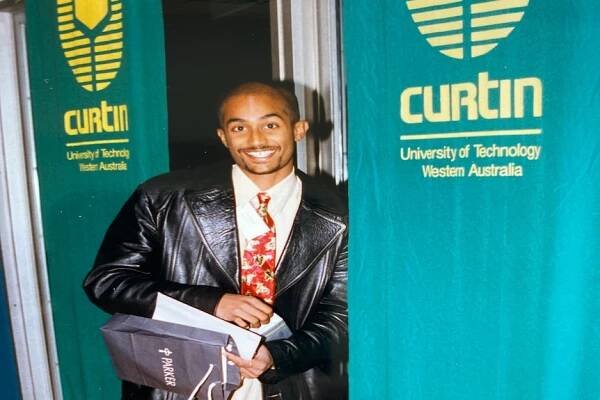 A man in a leather jacket wearing a red tie