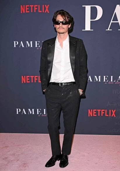 Dylan Jagger Lee poses in a black suit
