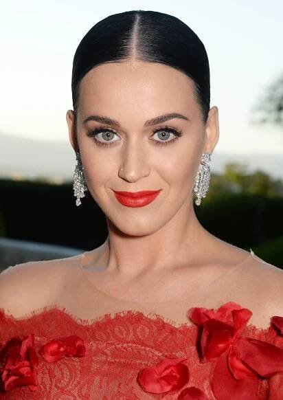 a woman with dark hair wearing red lipstick