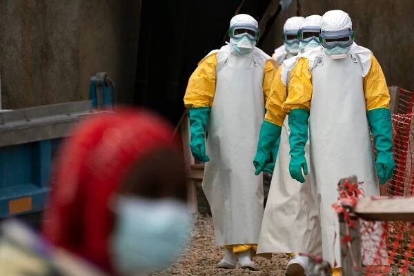 Health workers dressed in protective gear begin their shift at an Ebola treatment center in Beni, Congo DRC.