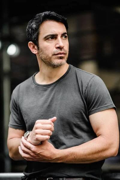 a man standing with his arms crossed in front of him
