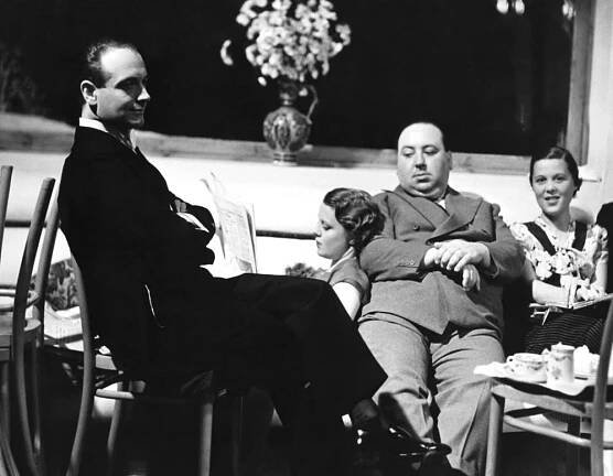 THE MAN WHO KNEW TOO MUCH, first three from left: Pierre Fresnay, Edna Best, director Alfred Hitchcock, on set, 1934 tmwktm1934y-fsct01(tmwktm1934y-fsct01)