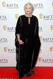 Elegant: Dame Siân Phillips, 90, looked elegant in a black kaftan with red floral detailing and black rhinestones within the petals
