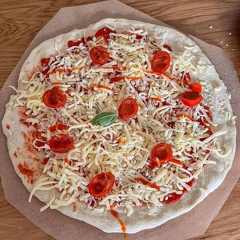 Uncooked tomato and nduja pizza.