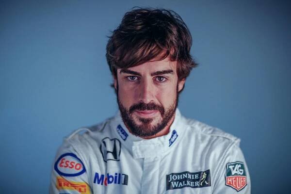 Fernando Alonso Geared Up in His Bright White Racing Suit Wallpaper