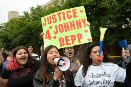 FAIRFAX, VA - MAY 27: (NY & NJ NEWSPAPERS OUT) Johnny Depp fans express their support of the actor outside court during the Johnny Depp and Amber Heard civil trial at Fairfax County Circuit Court on May 27, 2022 in Fairfax, Virginia. Depp is seeking $50 million in alleged damages to his career over an op-ed Heard wrote in the Washington Post in 2018.(Photo by Cliff Owen/Consolidated News Pictures/Getty Images)