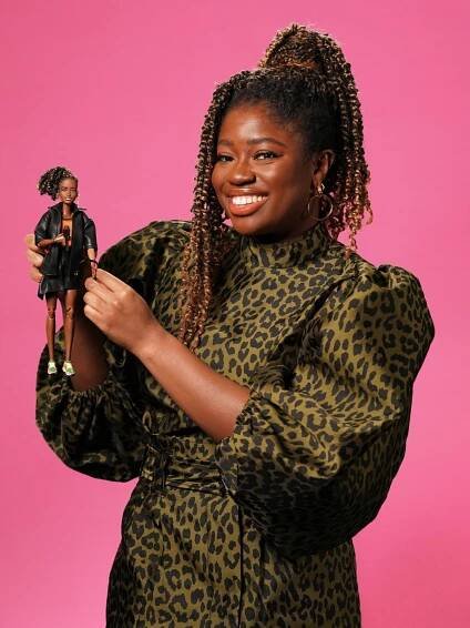 British radio broadcaster Clara Amfo holding a Barbie doll created in her likeness