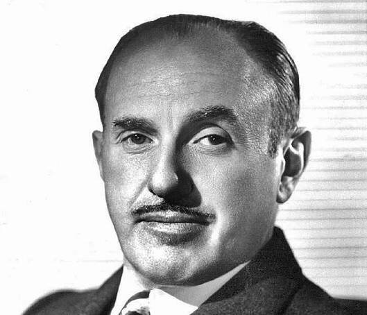 B&W Press photo of Jack Warner wearing suit and looking at camera - 1955