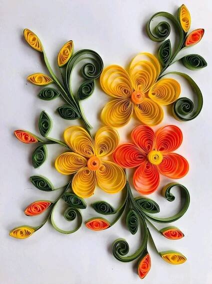 paper quilled flowers are arranged on a white surface with green stems and orange petals