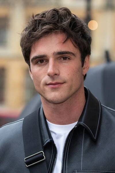 a man in a leather jacket looking at the camera