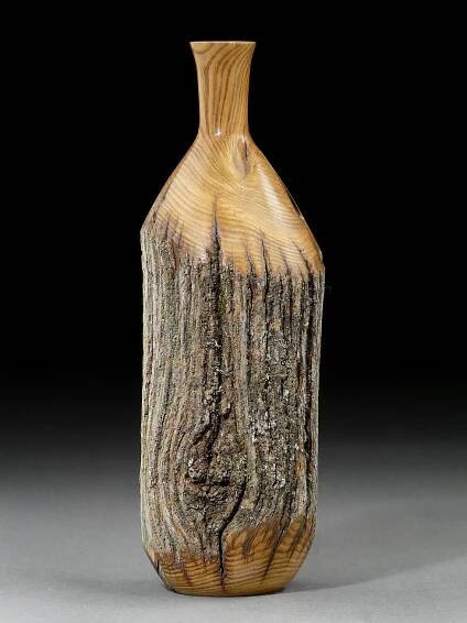 a wooden vase sitting on top of a table