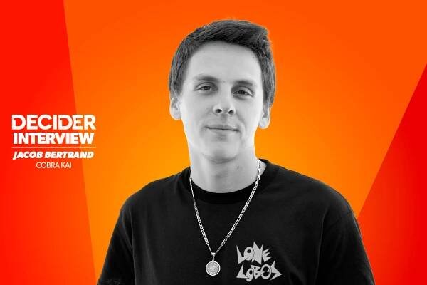 Jacob Bertrand in black and white on a bright orange background