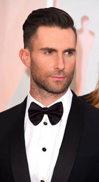 a man in a tuxedo and bow tie