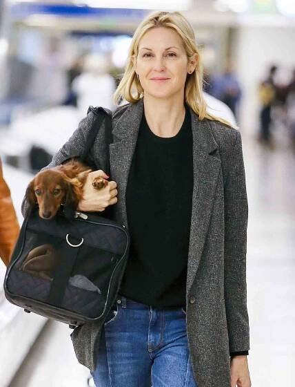 EXCLUSIVE: Makeup free Kelly Rutherford gives her dog a lift at LAX Airport in Los Angeles